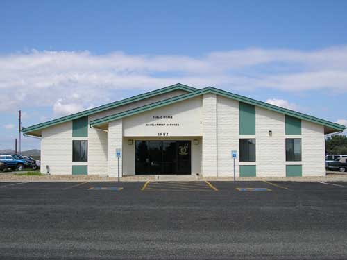 The Public Works Office with white brick and mint colored trim